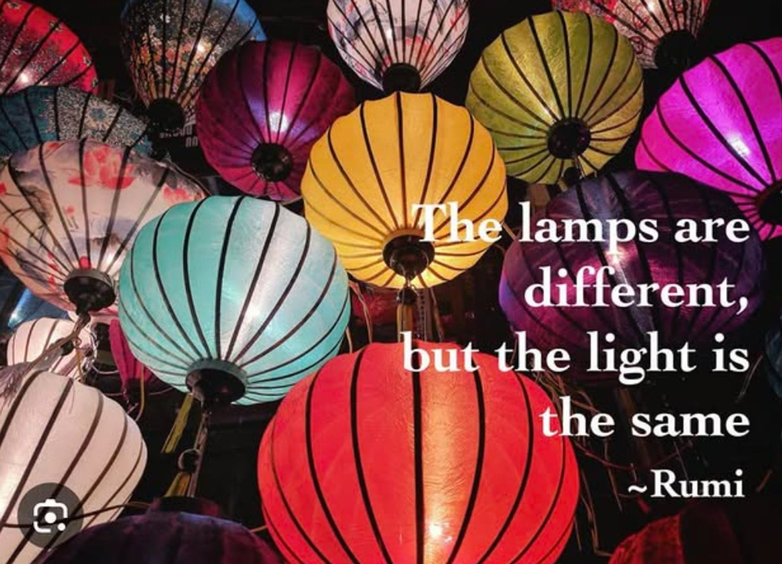 Colorful paper lanterns glowing against a dark sky.